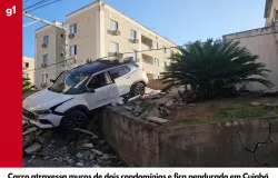 Carro bate em muros, fica pendurado entre condom�nios e motorista embriagado foge