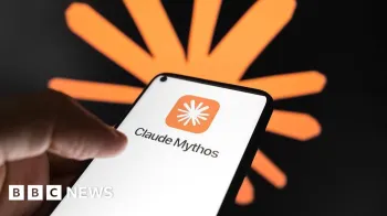 Uma m�o segurando um smartphone usando o aplicativo Claude Mythos da Anthropic. As palavras 'Claude Mythos' aparecem na tela branca com o logotipo da empresa acima. Atr�s da m�o e do telefone, h� outra vers�o do logotipo em uma parede preta.