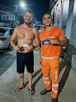 Fabiano (D) entrega o documento a Felipe ap�s encontrar a bolsa - Divulga�ao / Comlurb